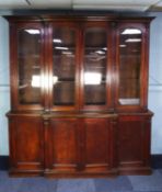 NINETEENTH CENTURY OAK BREAKFRONT LIBRARY BOOKCASE, the moulded cornice above four glazed cupboard