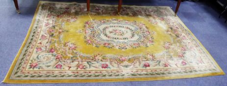 WASHED CHINESE CARPET OF AUBUSSON DESIGN, with off-white and floral centre medallion, on a plain