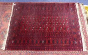 TURKOMAN BOKHARA FINELY KNOTTED RUG, with three rows of black, white and red stenciled primary