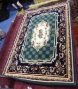 MACHINE WOVEN SMALL CARPET, of Eastern style with cream and floral centre medallion on a green and