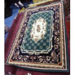 MACHINE WOVEN SMALL CARPET, of Eastern style with cream and floral centre medallion on a green and