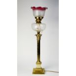 VICTORIAN BRASS CORINTHIAN COLUMN OIL TABLE LAMP, of fluted form with ruby tinted etched glass