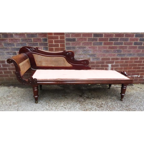 NINETEENTH CENTURY CARVED MAHOGANY AND CANED CHAISE LONGUE, of typical form with carved scroll end.