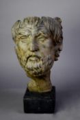 CAST METAL FACE MASK OF A ROMAN EMPEROR, after the classical original, on a black composition oblong