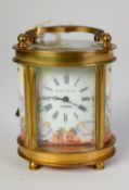 EARLY 20th CENTURY SMALL OVAL GILDED BRASS and ENAMELLED CARRIAGE CLOCK, the movement stamped '