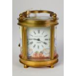 EARLY 20th CENTURY SMALL OVAL GILDED BRASS and ENAMELLED CARRIAGE CLOCK, the movement stamped '