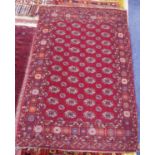 PAKISTAN BOKHARA LARGE RUG, with four rows of white, crimson and orange guls on a crimson field,