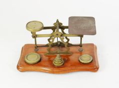 BRASS POSTAL BALANCE SCALES, on wooden oblong base with a set of brass weights