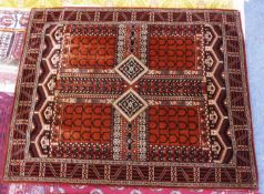 MACHINE WOVEN CHENILLE RUG, of Caucasian style, the quartered field brick red with black stenciled