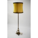 GILT METAL STANDARD LAMP with fluted column, on ornate triform rococo base, the top with uplighter