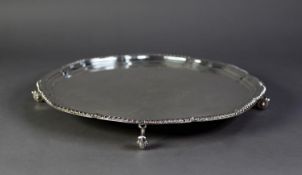 SILVER LARGE, PLAIN CIRCULAR SALVER, with shaped and step moulded border with gadroon edge, raised