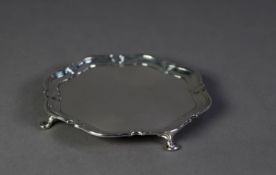 SILVER CIRCULAR CARD TRAY with shaped and step moulded border, raised on four pad feet, 6 ¼? (15.