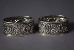 PAIR OF VICTORIAN SILVER OVAL NAPKIN RINGS, repoussé with flowers and scrolls, Birmingham 1897,