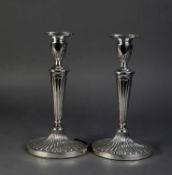 PAIR OF SILVER OVAL TABLE CANDLESTICKS, each with all-over fan lobed decoration, urn shaped