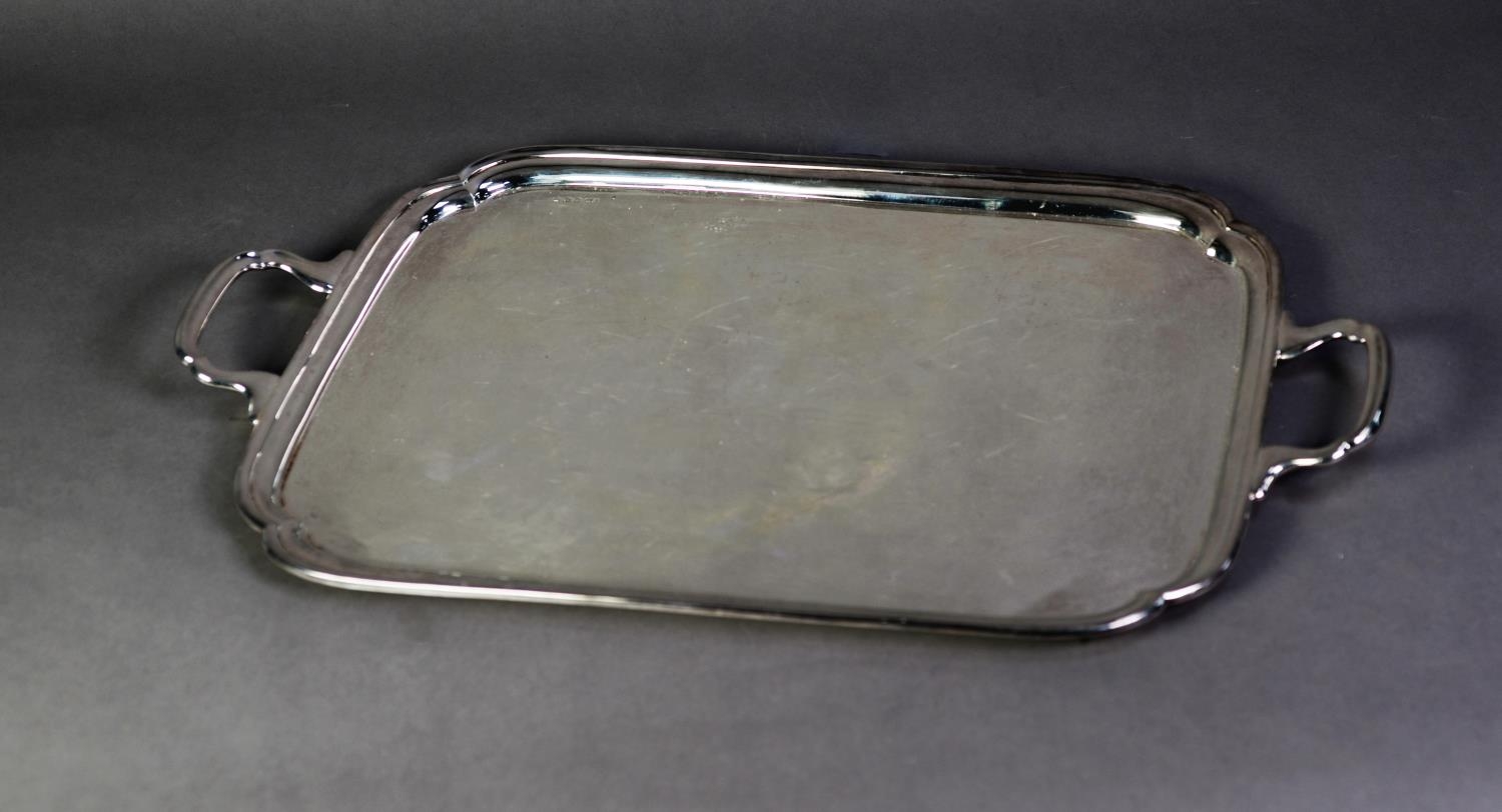 SILVER PLAIN OBLONG TWO-HANDLED TRAY with incuse corners, 22? (55.8cm) long over the handles, 64 ozs