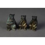SET OF THREE SILVER SEATED BEAR PATTERN CONDIMENT RECEIVERS, viz pepper and salt with removable