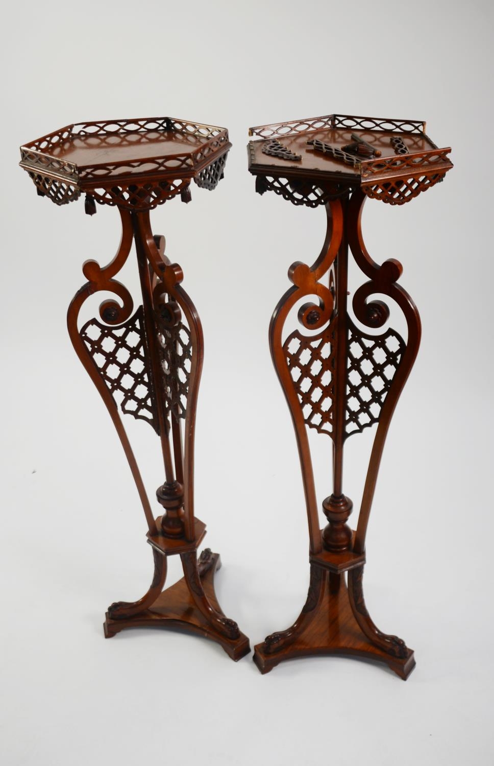 PAIR OF CHIPPENDALE STYLE FRET CARVED MAHOGANY TORCHÈRE STANDS with hexagonal gallery tops, three