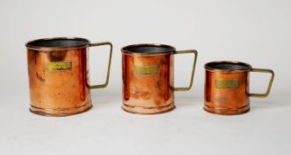 SET OF THREE COPPER GRADUATED GRAIN MEASURES and a BRASS POSTAL BALANCE SCALE with brass nesting