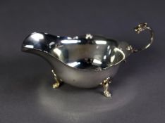 SILVER SAUCE BOAT, oval with cyma edge, free scroll handle with dragon?s head terminal, raised on