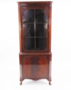 GEORGIAN STYLE MAHOGANY DOUBLE CORNER CUPBOARD, with astragal glazed door over a panel door, on