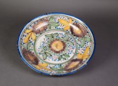 19th CENTURY CONTINENTAL FAYENCE POLYCHROME DECORATED SHALLOW DISH, 13? (33cm) diameter (cracked)