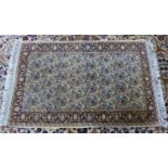 HERAT, PERSIAN RUG, WITH ALL-OVER REPEAT FLOWERING SHRUB AND PEAR PATTERN on an off-white field,