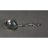 CONTINENTAL SILVER SERVING SPOON, with shallow circular bowl, cast handle with female figure top