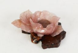 CHINESE, POSSIBLY REPUBLIC PERIOD CARVED ROSE PINK QUARTZITE PEONY with issuing leafage, on a root