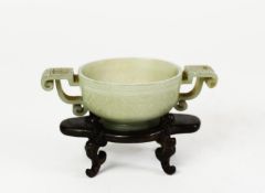 CHINESE QING DYNASTY CELADON JADE ARCHAISTIC BOWL with angular scroll handle, shallowly carved