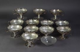 SET OF TWELVE SILVER SUNDAE DISHES, cut card pierced with shaped tops, single scroll handle, on stem