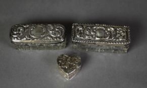 TWO EDWARDIAN CUT GLASS PIN BOXES WITH SCROLL EMBOSSED SILVER COVERS, Birmingham 1903 and 1904, both