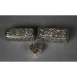 TWO EDWARDIAN CUT GLASS PIN BOXES WITH SCROLL EMBOSSED SILVER COVERS, Birmingham 1903 and 1904, both