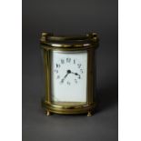 EARLY TWENTIETH CENTURY GILT POLISHED BRASS CASED OVAL CARRIAGE CLOCK, with top carrying handle