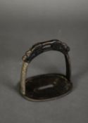 AGED ORIENTAL CAST METAL STIRRUP, cast with stylised dragon mask and with intricate scroll detail to