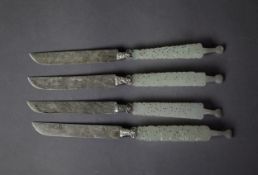 SET OF FOUR FAR EASTERN DESSERT KNIVES, with foliate engraved silver coloured metal blades, carved