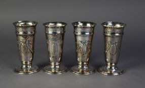 SET OF FOUR LATE VICTORIAN SILVER TRUMPET VASES, repoussé with festoons and ribbon bows, on circular