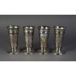 SET OF FOUR LATE VICTORIAN SILVER TRUMPET VASES, repoussé with festoons and ribbon bows, on circular