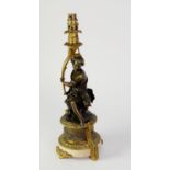 PATINATED AND GILT BRONZE FIGURAL TABLE LAMP, modelled as a seated female figure holding a