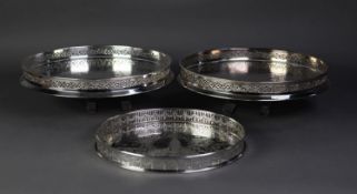 PAIR OF ITALIAN ELECTROPLATE ENGRAVED CIRCULAR TRAYS, with cut card pierced gallery sides, on