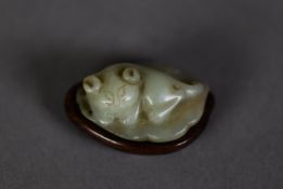CHINESE CARVED GREEN JADE MODEL OF A CAT, modelled seated on a leaf, 1 ¾? (4.5cm) long, and the