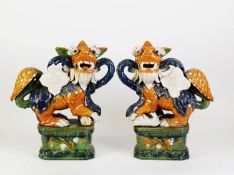 PAIR OF, PROBABLY 20TH CENTURY, SAN TSAI ENAMELLED BUDDHISTIC LIONS, on canted oblong bases, 17? (