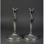 PAIR OF SILVER OVAL TABLE CANDLESTICKS, each with all-over fan lobed decoration, urn shaped