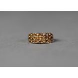 9ct GOLD RING with broad pierced and trellis pattern top with fine beads surmounting, ring size P,
