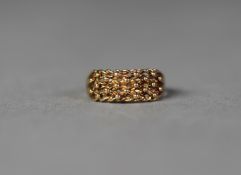 9ct GOLD RING with broad pierced and trellis pattern top with fine beads surmounting, ring size P,