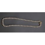 SINGLE STRAND NECKLACE OF 57 UNIFORM PEARLS WITH AN 18ct GOLD, DIAMOND AND PEARL FLORAL CLASP with