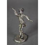 ISRAELI SILVER COLOURED METAL CASED FIGURE of a man in dancing pose, on oval base, 5 ½? (13.9cm)