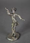 ISRAELI SILVER COLOURED METAL CASED FIGURE of a man in dancing pose, on oval base, 5 ½? (13.9cm)