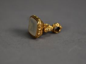 ANTIQUE GOLD COLOURED METAL FOB SEAL (unmarked), inset with a white onyx base incised with an