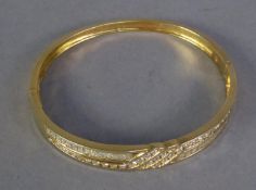 14ct GOLD & DIAMOND HINGE-OPENING BANGLE with two part crossover top forming a triple section in the