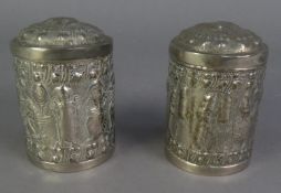 PAIR OF INDIAN EMBOSSED WHITE METAL CYLINDRICAL BOXES AND COVERS, repousse autour with figures and